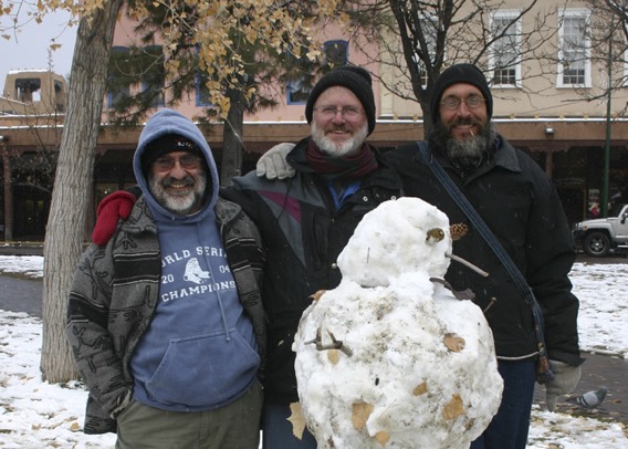 Carl, Jim, and Joseph pose with snowman on the plaza in Santa Fe
